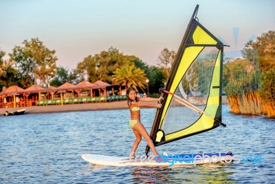 Little Girl Winsurfing On Ada Bojana, Montenegro Stock Photo