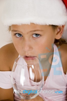 Little Girl With Christmas Hat And Glass Stock Photo