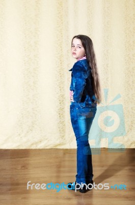 Little Girl With Long Hair In A Blue Denim Suit Stock Photo