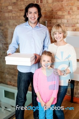 Little Girl With Parents Posing Casually Stock Photo