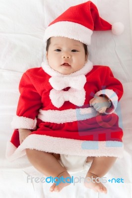 Little Girl With Santa Costume Stock Photo