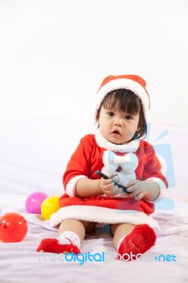 Little Girl With Santa Costume Stock Photo