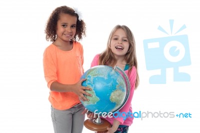 Little Girls Playing With Globe Stock Photo