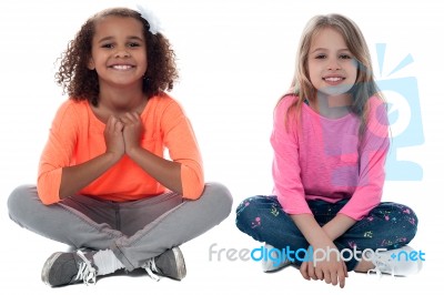 Little Girls Sitting On Floor Stock Photo