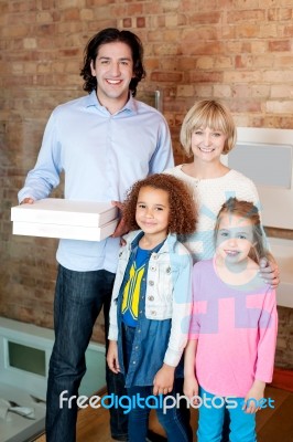 Little Girls With Parents Posing Casually Stock Photo