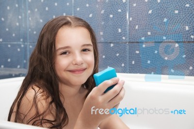 Little Smiling Girl Holding Soap Stock Photo