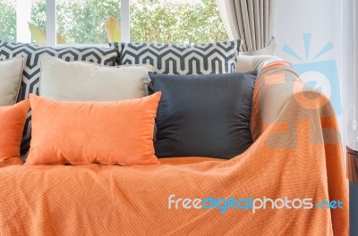 Living Room With Orange Color Blanket With Pillows On Sofa Stock Photo