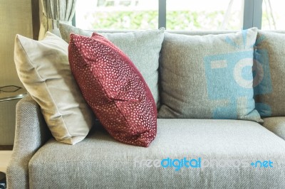 Living Room With Row Of Pillows On Sofa At Home Stock Photo