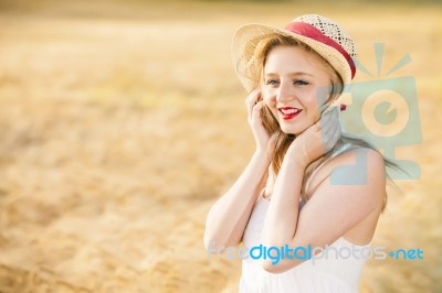 Lonely Beautiful Young Blonde Girl In White Dress With Straw Hat… Stock Photo