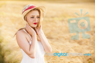 Lonely Beautiful Young Blonde Girl In White Dress With Straw Hat… Stock Photo