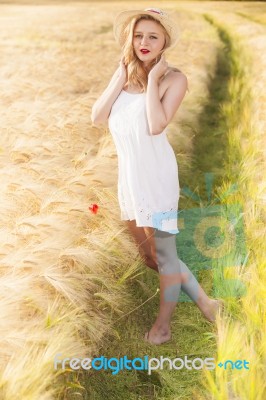 Lonely Beautiful Young Blonde Girl In White Dress With Straw Hat… Stock Photo