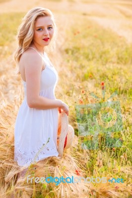 Lonely Beautiful Young Blonde Girl In White Dress With Straw Hat… Stock Photo