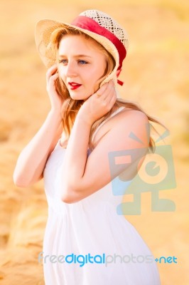 Lonely Beautiful Young Blonde Girl In White Dress With Straw Hat… Stock Photo