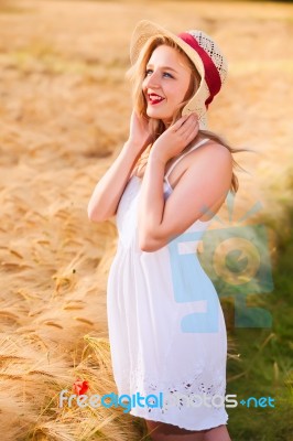 Lonely Beautiful Young Blonde Girl In White Dress With Straw Hat… Stock Photo