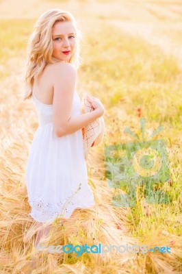 Lonely Beautiful Young Blonde Girl In White Dress With Straw Hat… Stock Photo