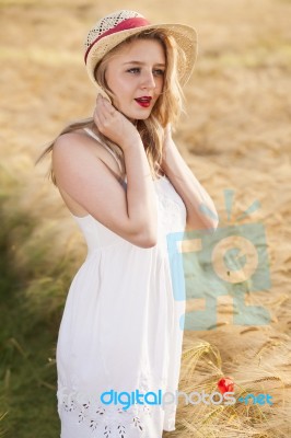 Lonely Beautiful Young Blonde Girl In White Dress With Straw Hat… Stock Photo