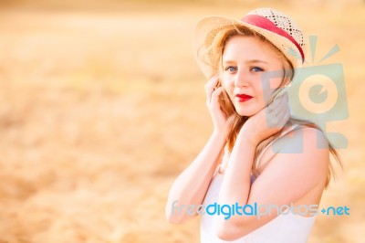 Lonely Beautiful Young Blonde Girl In White Dress With Straw Hat… Stock Photo