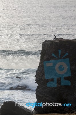 Lonely Man On Cliff Stock Photo