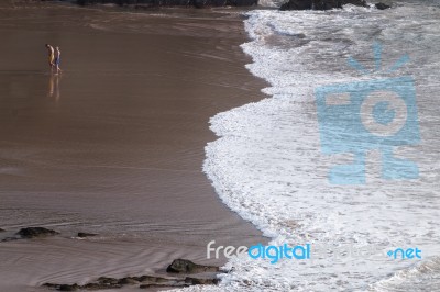 Lonely People Walk On Beach Stock Photo