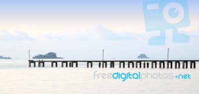 Long Wooden Pier Port On Morning Beach Stock Photo