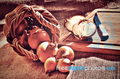 Loose Onions Scattered From Wicker Basket Stock Photo