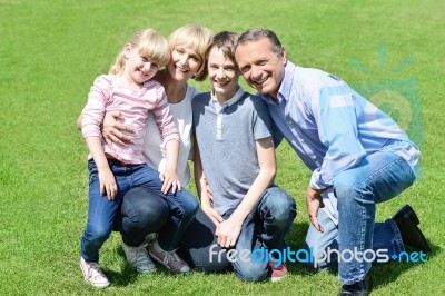 Lovable Family Posing In The Park Stock Photo