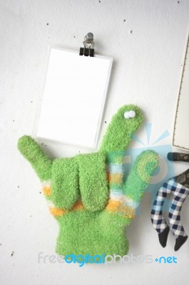 Love Sign , Photo Blank With Green Knitted Gloves On White Broad… Stock Photo