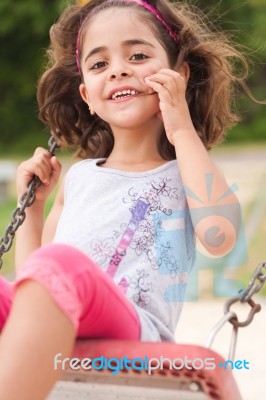 Lovely Girl On A Swing In The Park Stock Photo