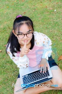 Lovely Girl With A Laptop On The Grass Stock Photo