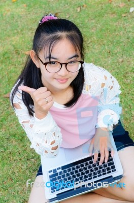 Lovely Girl With A Laptop On The Grass Stock Photo