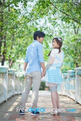 Loving Asian Couple Under Tree In The Park Stock Photo