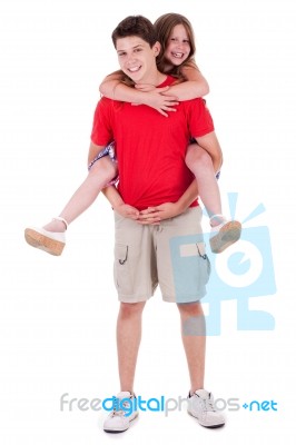 Loving Brother Gives Piggyback To His Beautiful Sister Stock Photo