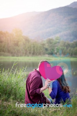 Loving Couple. Beautiful Young Love Couple Holding Paper Hearts Stock Photo