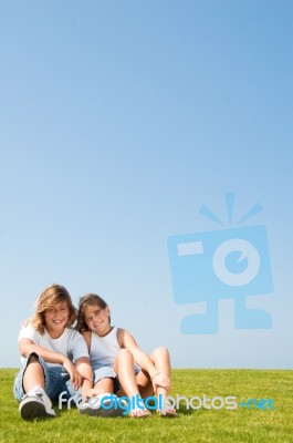 loving friends sitting in lawn Stock Photo