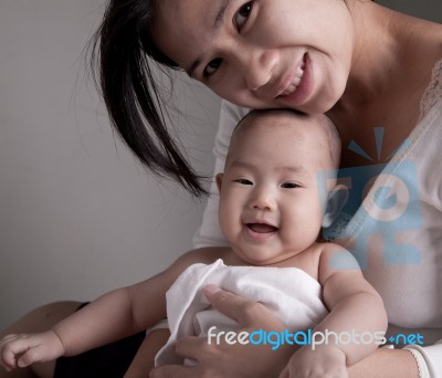 Loving Mother Holding Baby Stock Photo