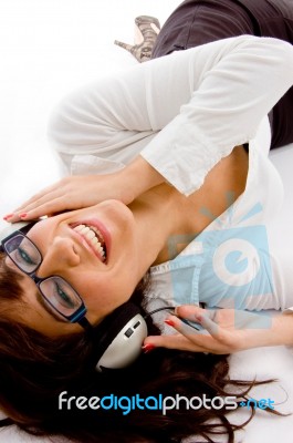 Lying Female Enjoying Music Stock Photo