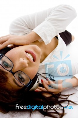 Lying Female Enjoying Music Stock Photo