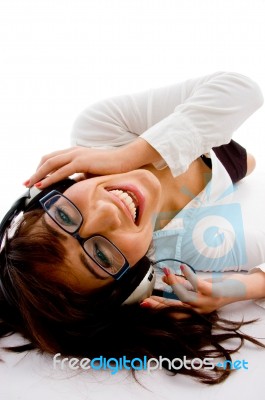 Lying Female Enjoying Music Stock Photo