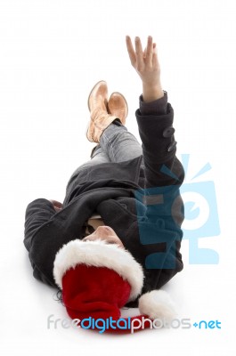 Lying Female Wearing Christmas Hat And Counting Fingers Stock Photo