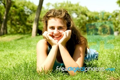 Lying Teenage Girl In Meadow Stock Photo