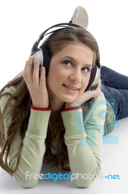 Lying Woman Enjoying Music Stock Photo