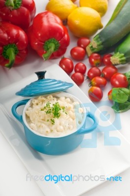 Mac And Cheese On A Blue Little Clay Pot Stock Photo