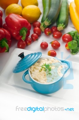 Mac And Cheese On A Blue Little Clay Pot Stock Photo