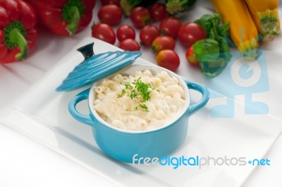 Mac And Cheese On A Blue Little Clay Pot Stock Photo