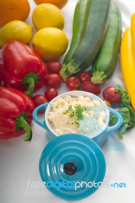 Mac And Cheese On A Blue Little Clay Pot Stock Photo