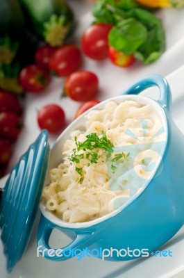 Mac And Cheese On A Blue Little Clay Pot Stock Photo