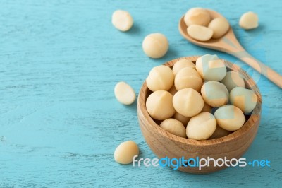 Macadamia On Blue Table Background Stock Photo