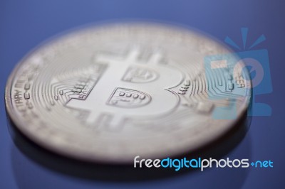 Macro Of Bitcoin Curency Dof On Blue Light Background Stock Photo