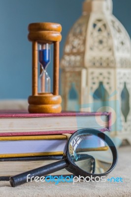 Magnifying Glass And Hourglass Stock Photo