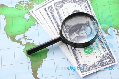 Magnifying Glass Black Frame And Currency On World Map Paper Stock Photo